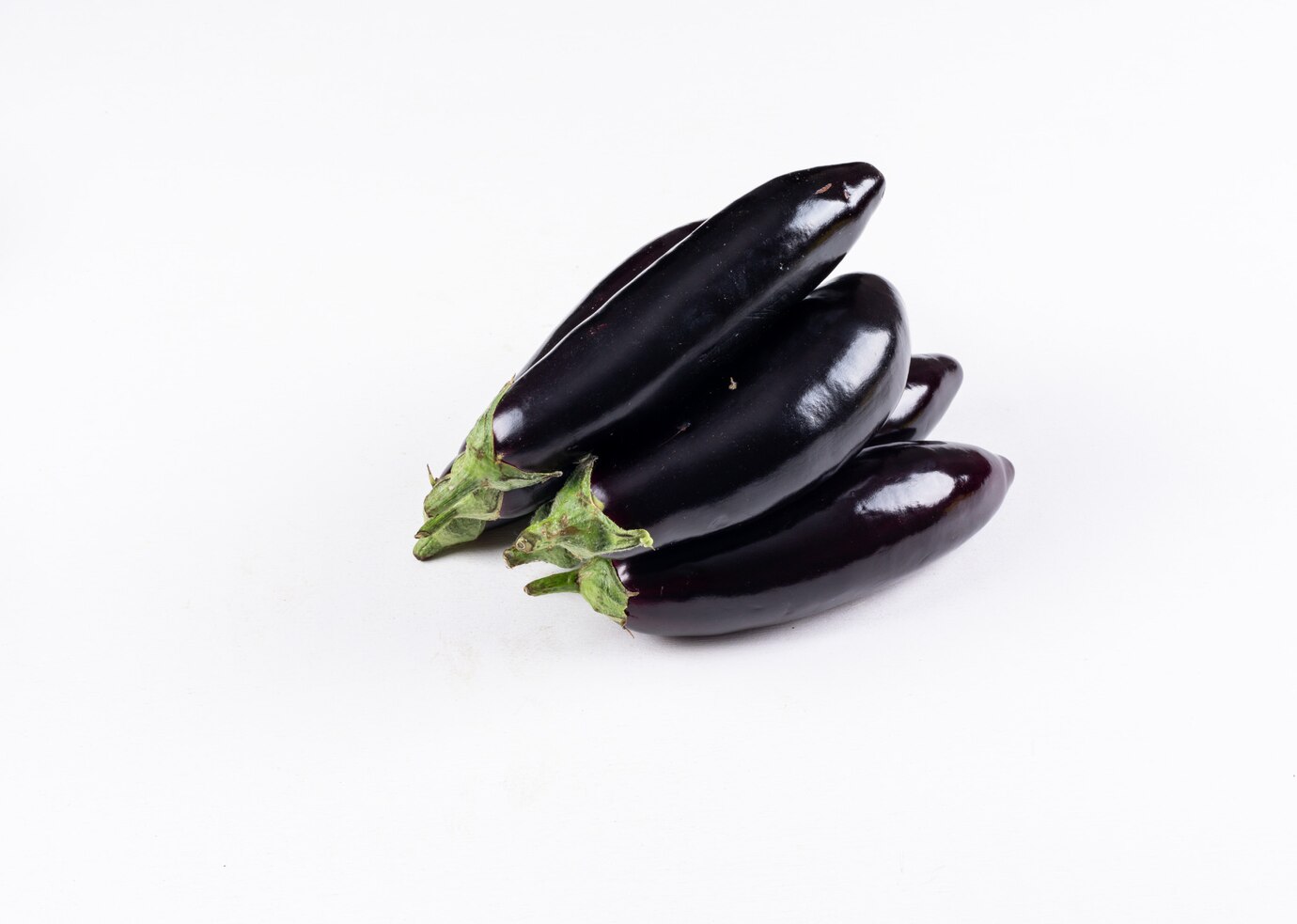 eggplants-one-another-high-angle-view-white_176474-2272